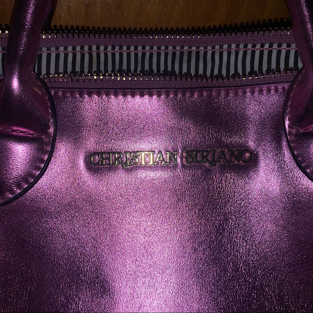 A beautiful pink purse with zebra interior